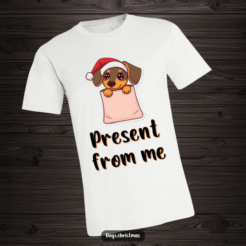 Funny Dachshund T-Shirt: A dachshund in a tiny Santa hat peeks from a gift bag, a humorous and adorable holiday surprise.